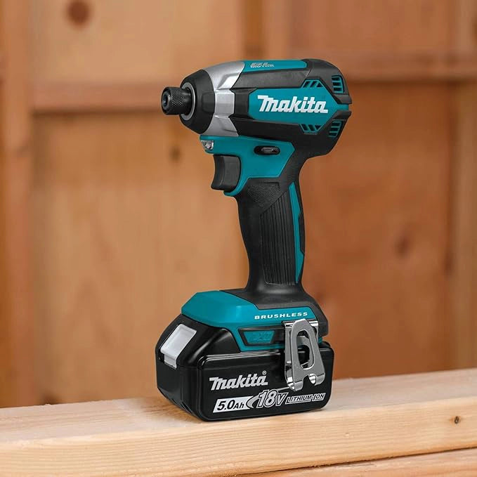 Makita XT291T tools in use on construction site, operator drilling into wood framing
