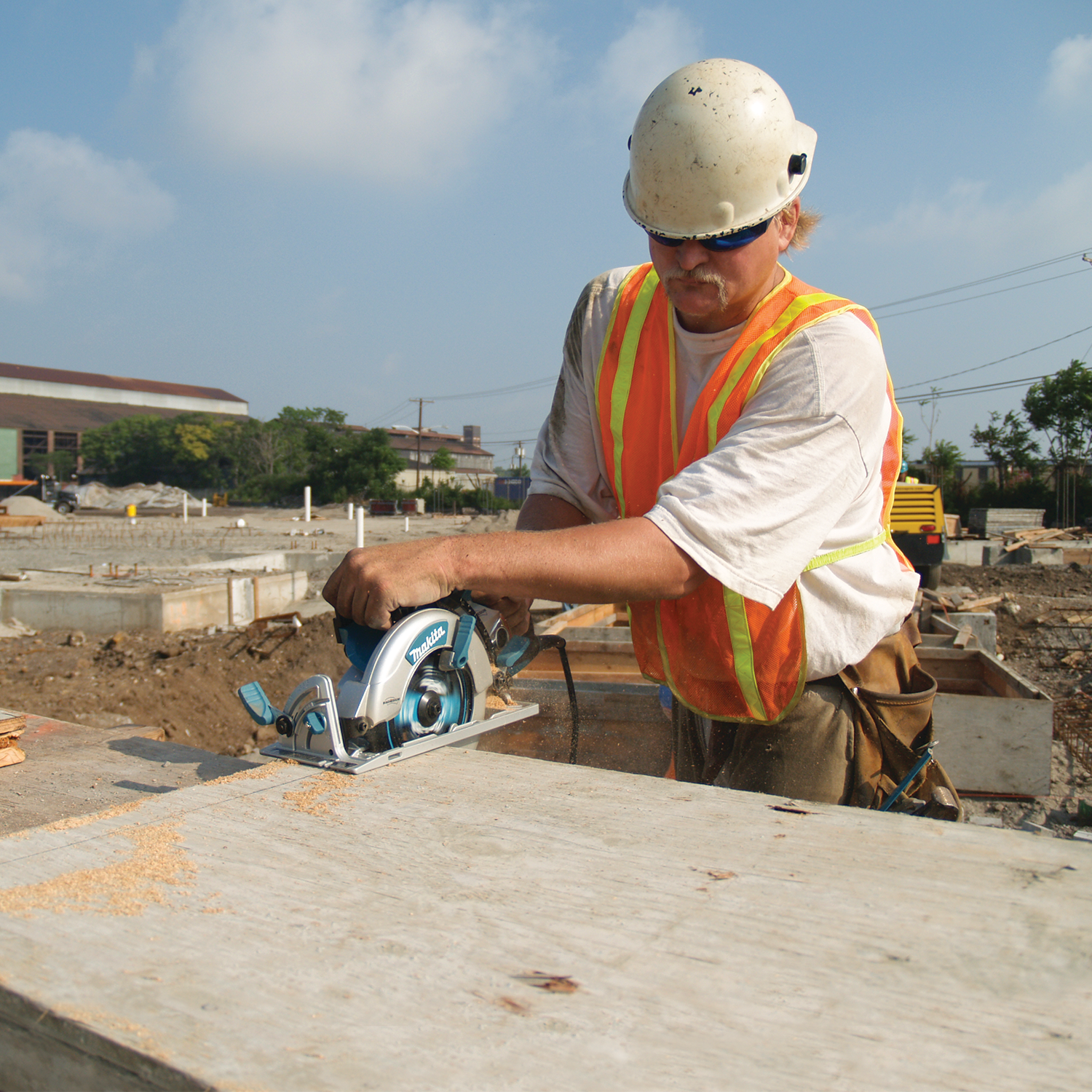 Makita Hypoid Saw operating at busy job site with visible results
