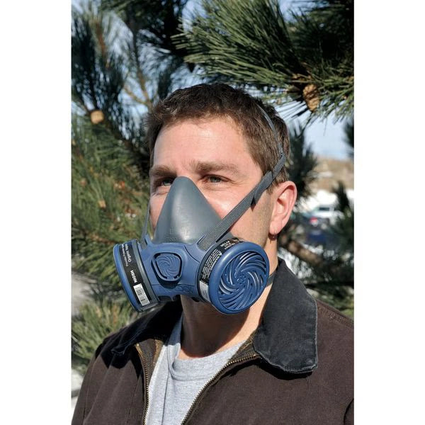 Man wearing Moldex 7000 half mask during demolition or containment setup
