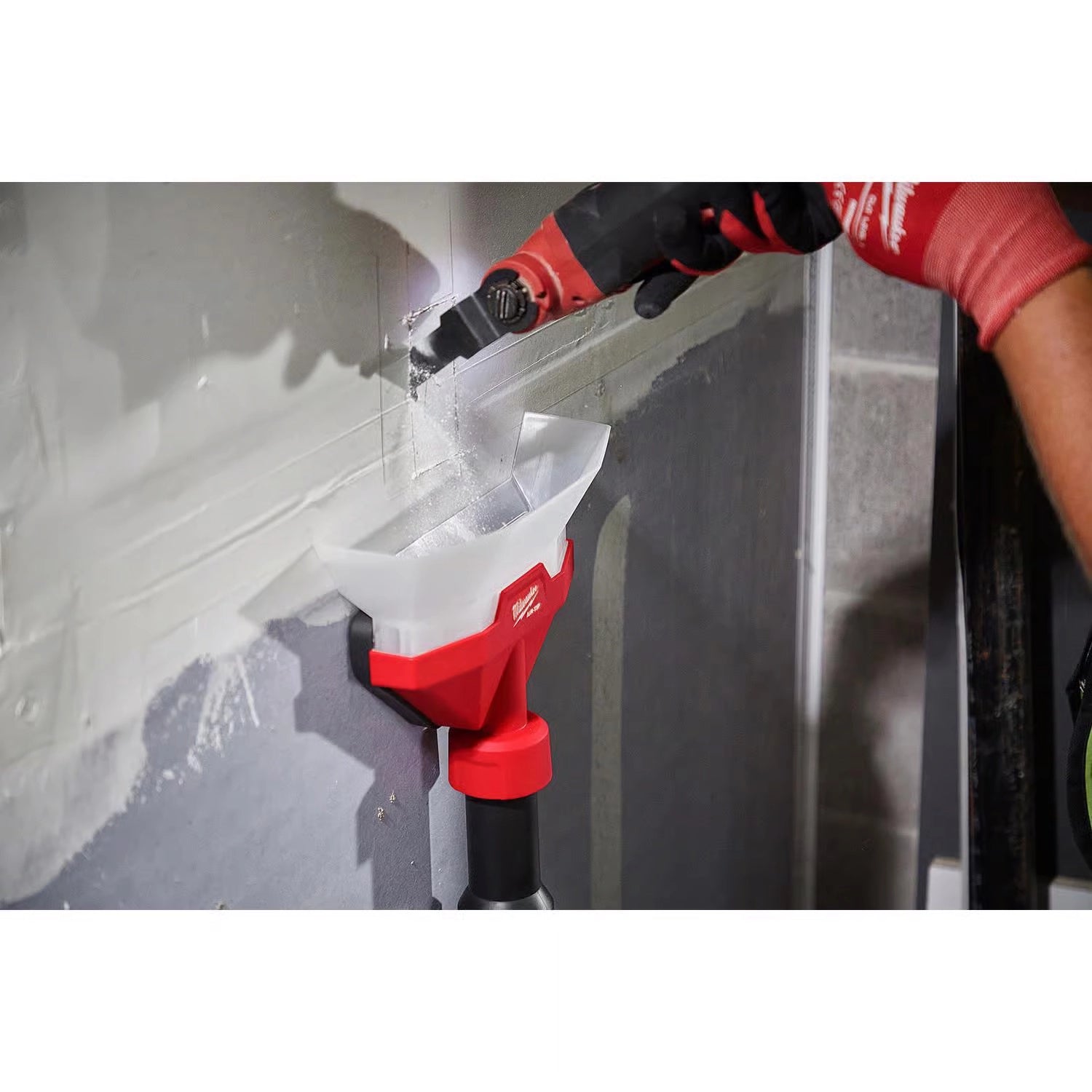 Milwaukee Air Tip Dust Collector in use collecting debris while drilling into drywall
