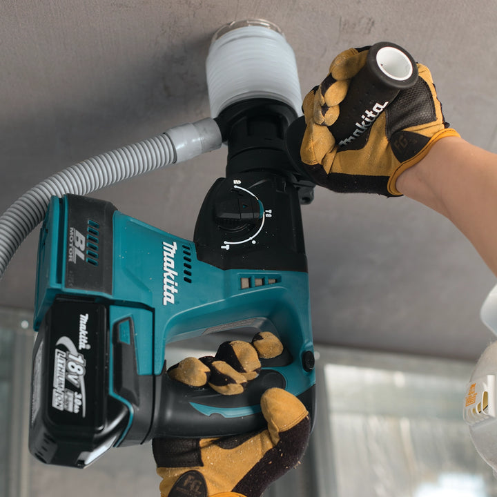 makita dust extraction cup actively collecting debris on indoor jobsite
