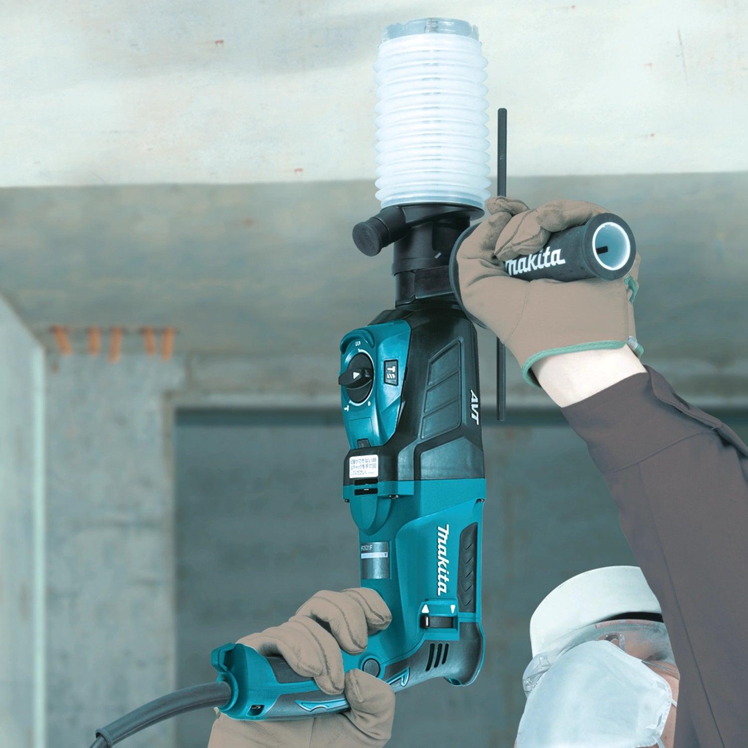 makita dust extraction cup in use on jobsite while drilling overhead
