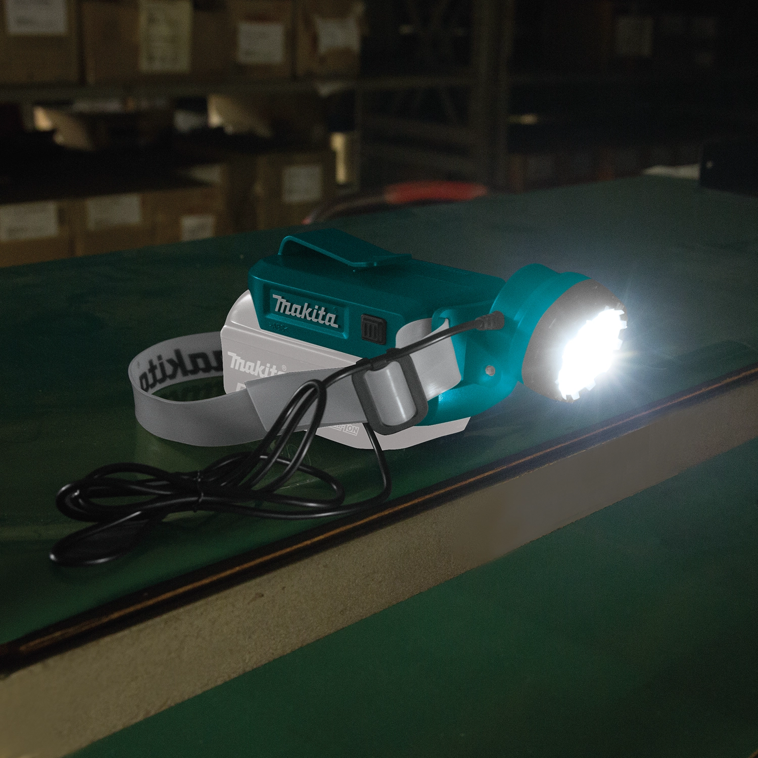 makita 18v lxt led headlamp in use at night on active construction site
