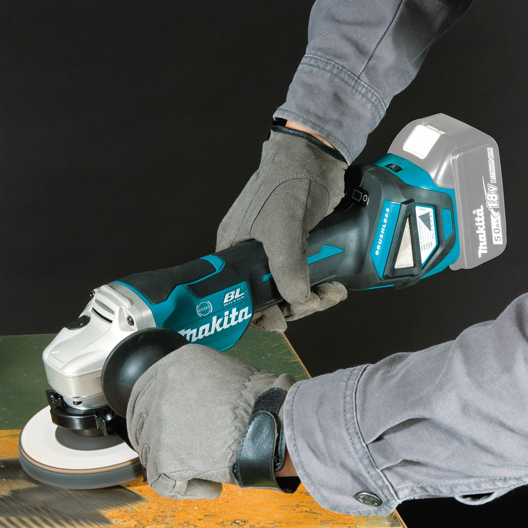 makita grinder in use on job site cutting metal pipe
