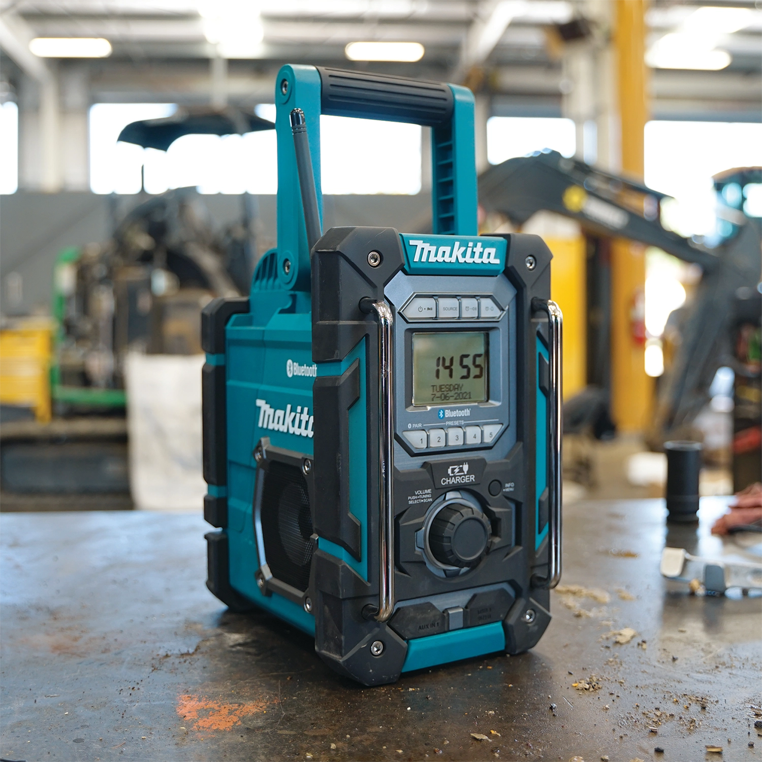 makita 18v lxt radio charger in use at construction job site providing sound and power
