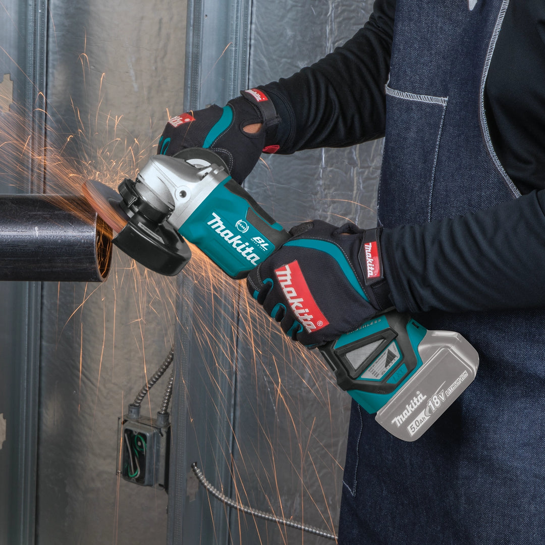 makita grinder being used in workshop grinding metal surface
