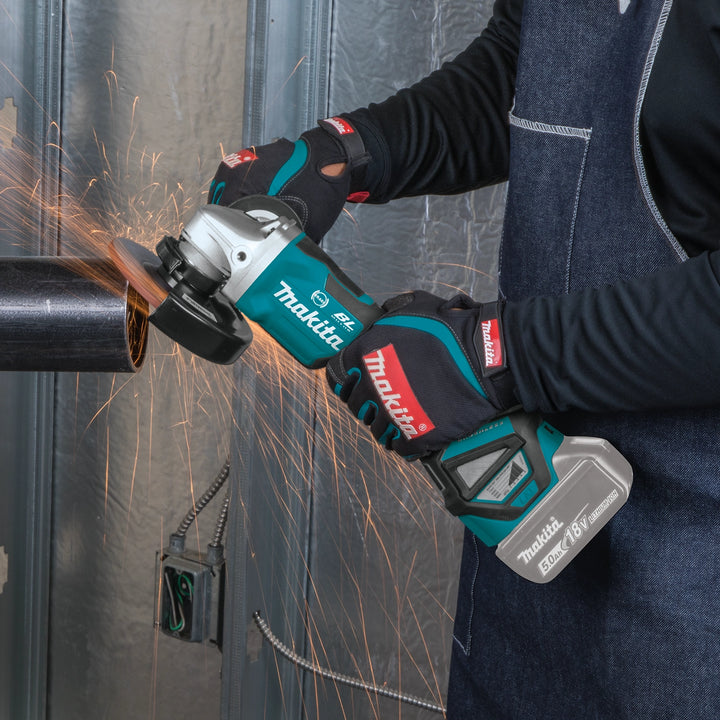 makita grinder being used in workshop grinding metal surface
