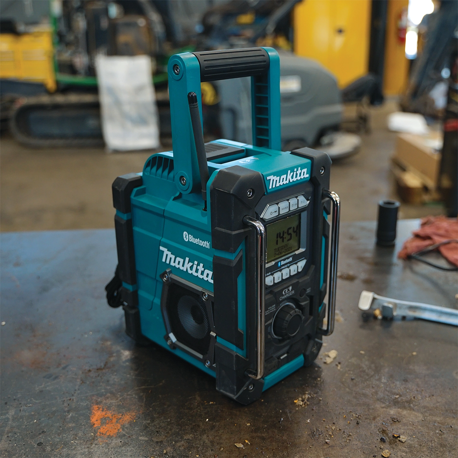 makita 18v lxt radio charger used on active job site with tools and debris around
