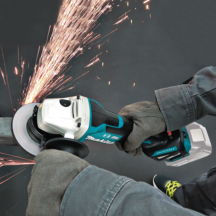 makita grinder operating on construction site with visible sparks
