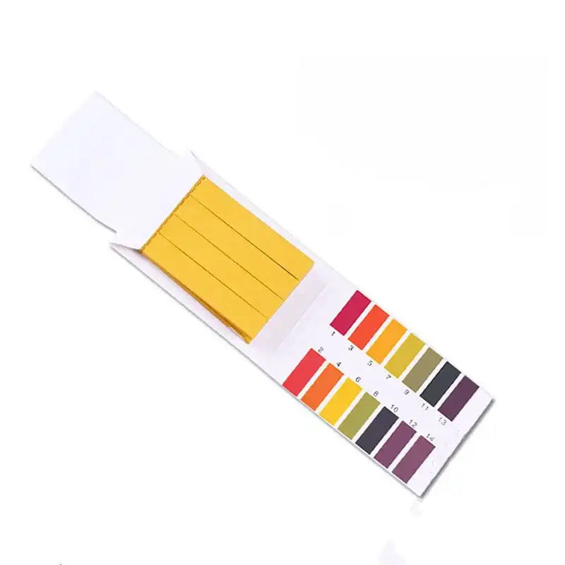 Overhead view of pH test strip booklet with yellow strips and color chart