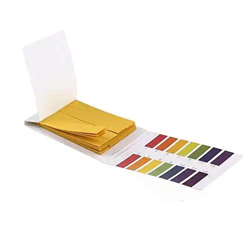 Open booklet of universal pH test strips with color-coded chart