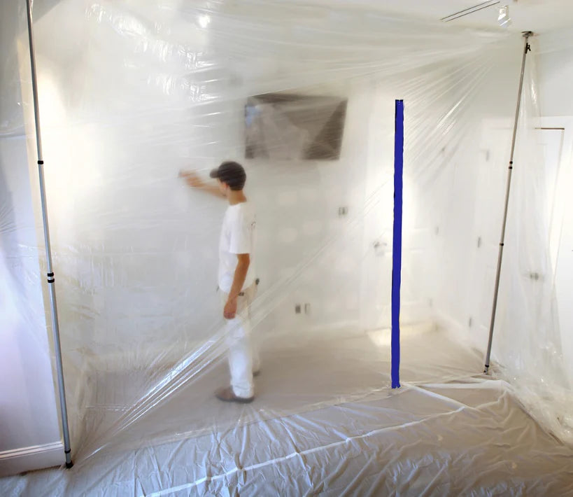 Plastic containment barrier with E-Z Up zipper installed in a white room
