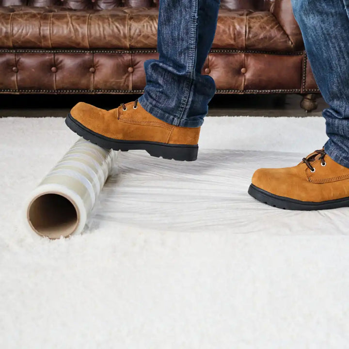 Presto carpet film installed over a light-colored synthetic rug for surface protection

