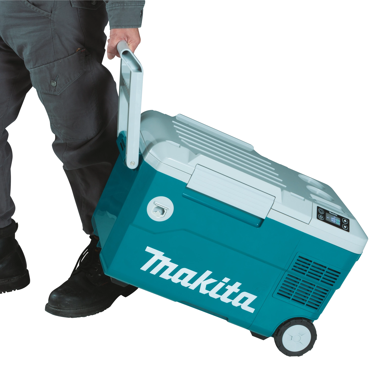 user pulling makita cooler warmer box on wheels across pavement using telescoping handle
