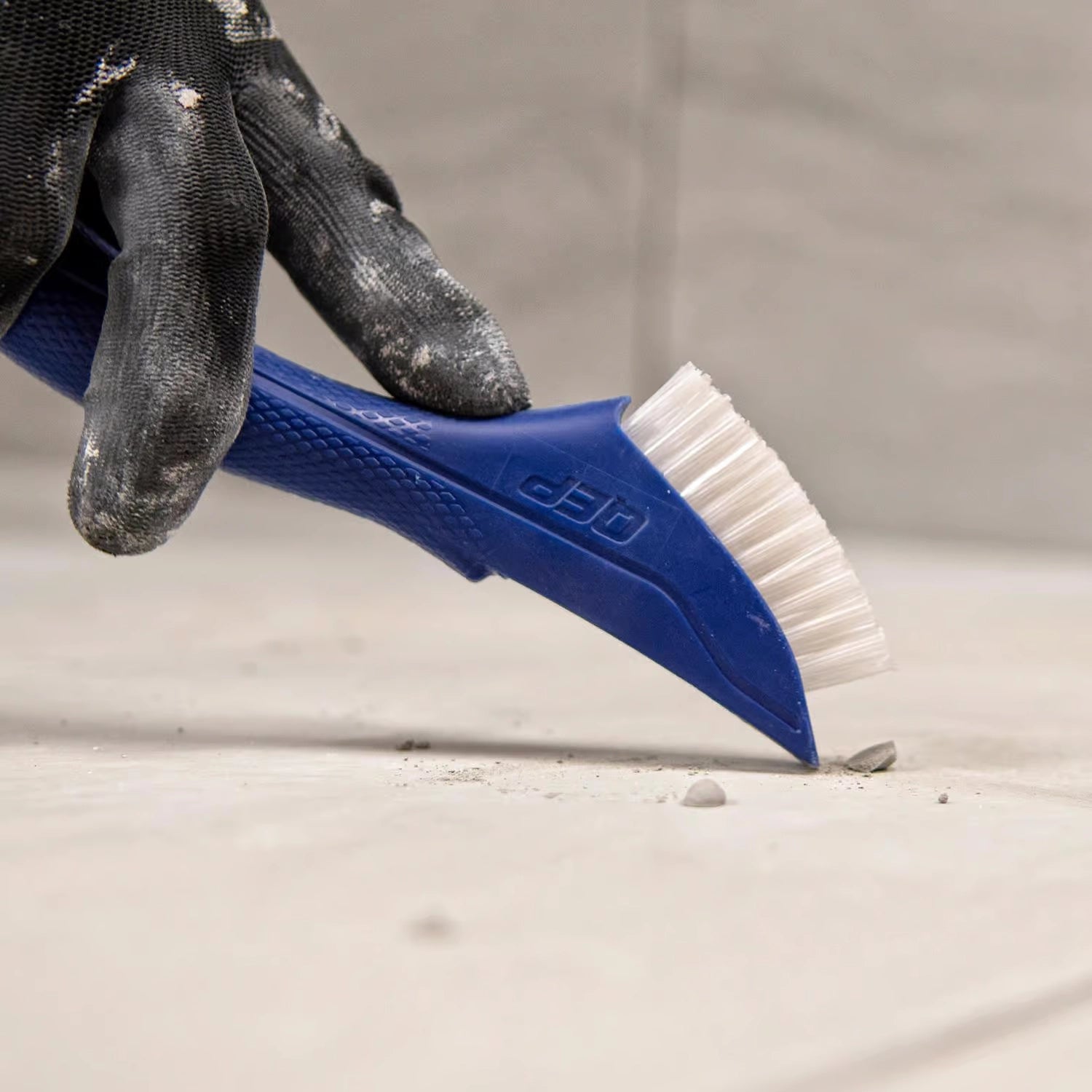 QEP Grout Cleaning Brush used to scrape away stuck-on debris from grout
