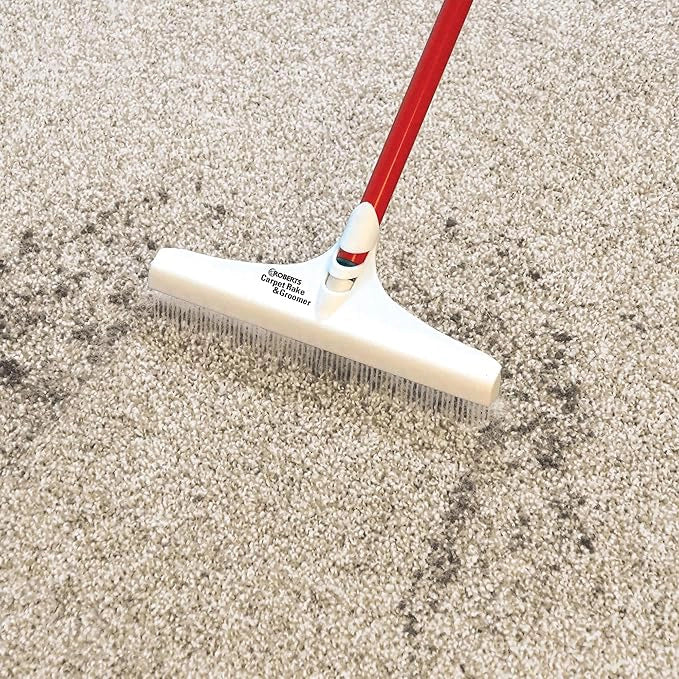 Roberts Carpet Rake after use with visible moisture and debris pulled from carpet
