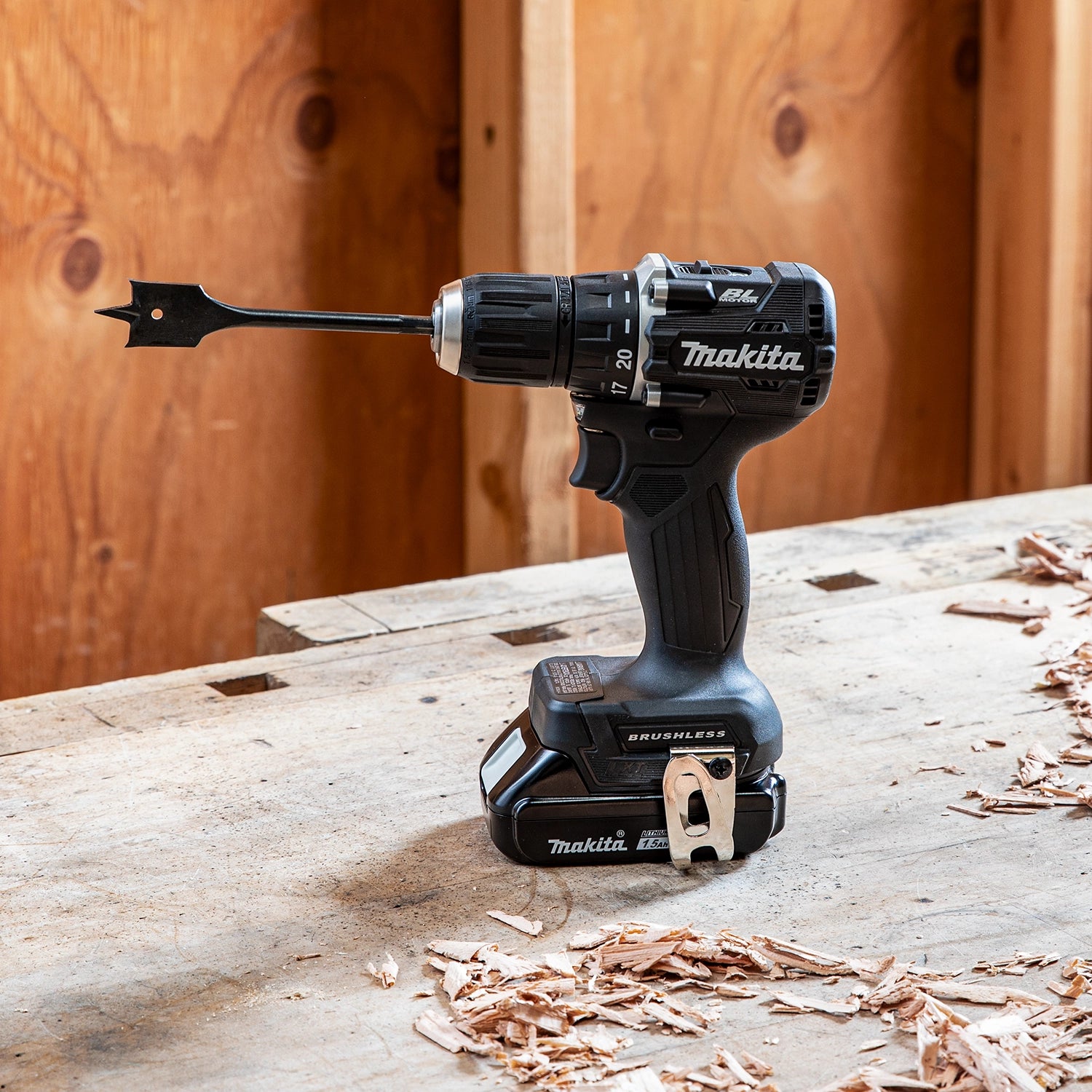 side profile of makita sub-compact drill in use at job site near framing
