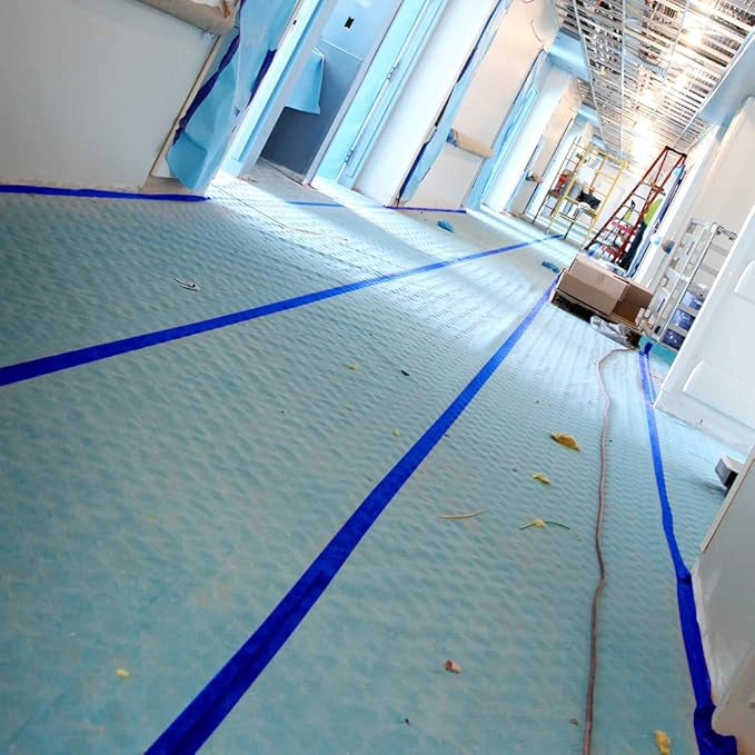 Trimaco Aqua Shield seam tape creating waterproof seal on vinyl-covered floor
