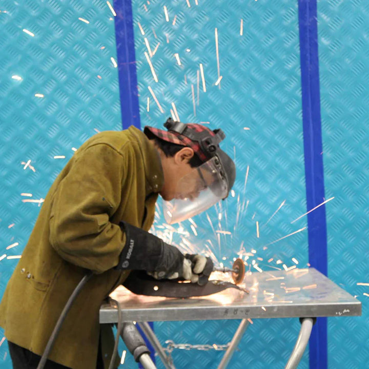 Trimaco AquaShield laid out behind worker operating tools in an active construction zone
