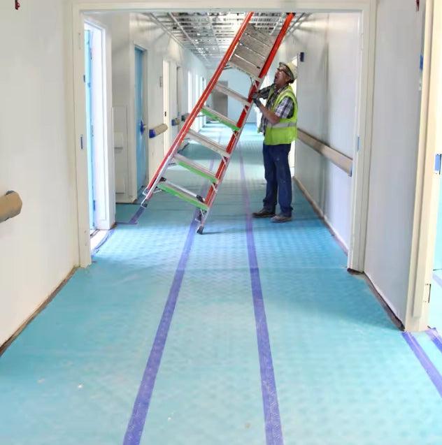 Trimaco AquaShield covering hallway flooring in a building under renovation
