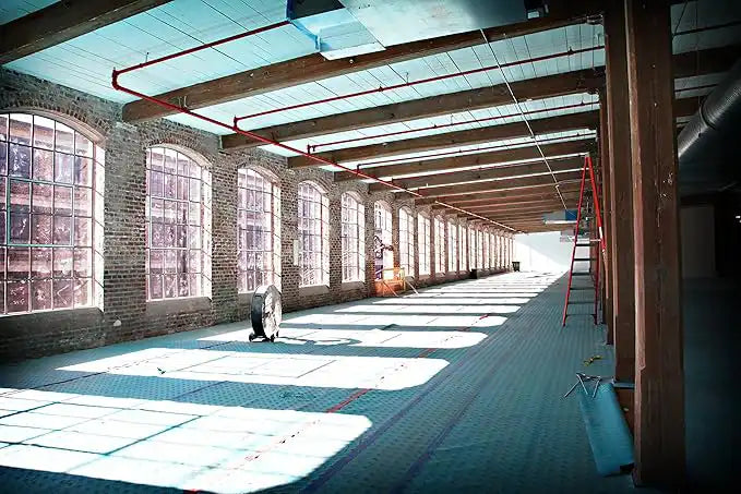 Large industrial space with Trimaco AquaShield surface protection covering floor and windows
