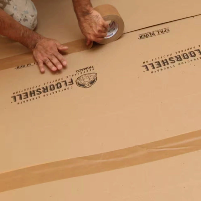Trimaco seam tape applied across seams of floor protection board during construction
