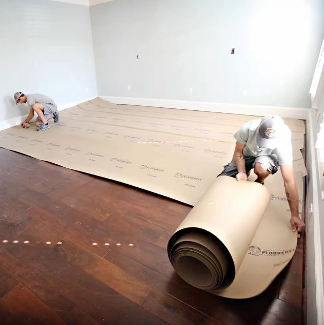 Trimaco FloorShell being rolled out across a floor during setup
