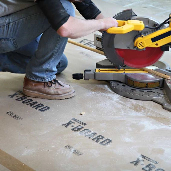 Trimaco X-Board protecting floor from saw dust during construction
