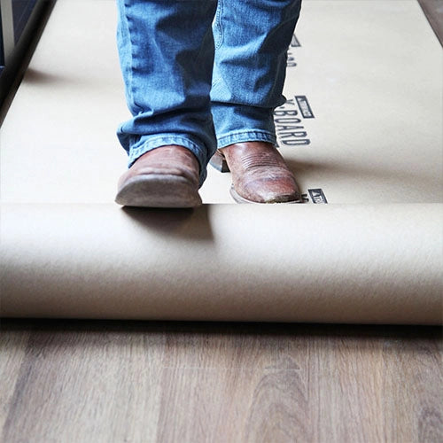 Trimaco X-Board being rolled out across hardwood floor
