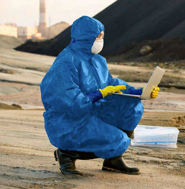 ViroGuard blue coveralls in active use during mold or biohazard remediation

