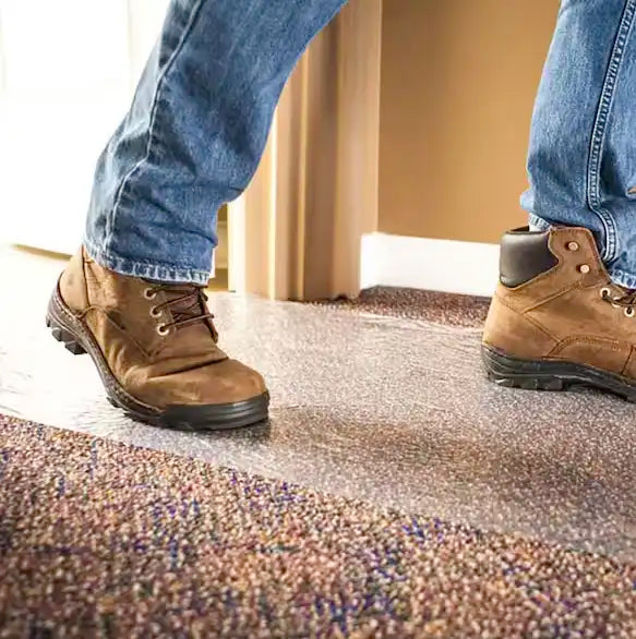 Person walking across Presto carpet film showing durable surface traction and protection
