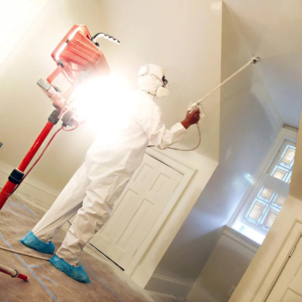 Worker wearing Trimaco blue shoe covers while actively working on job
