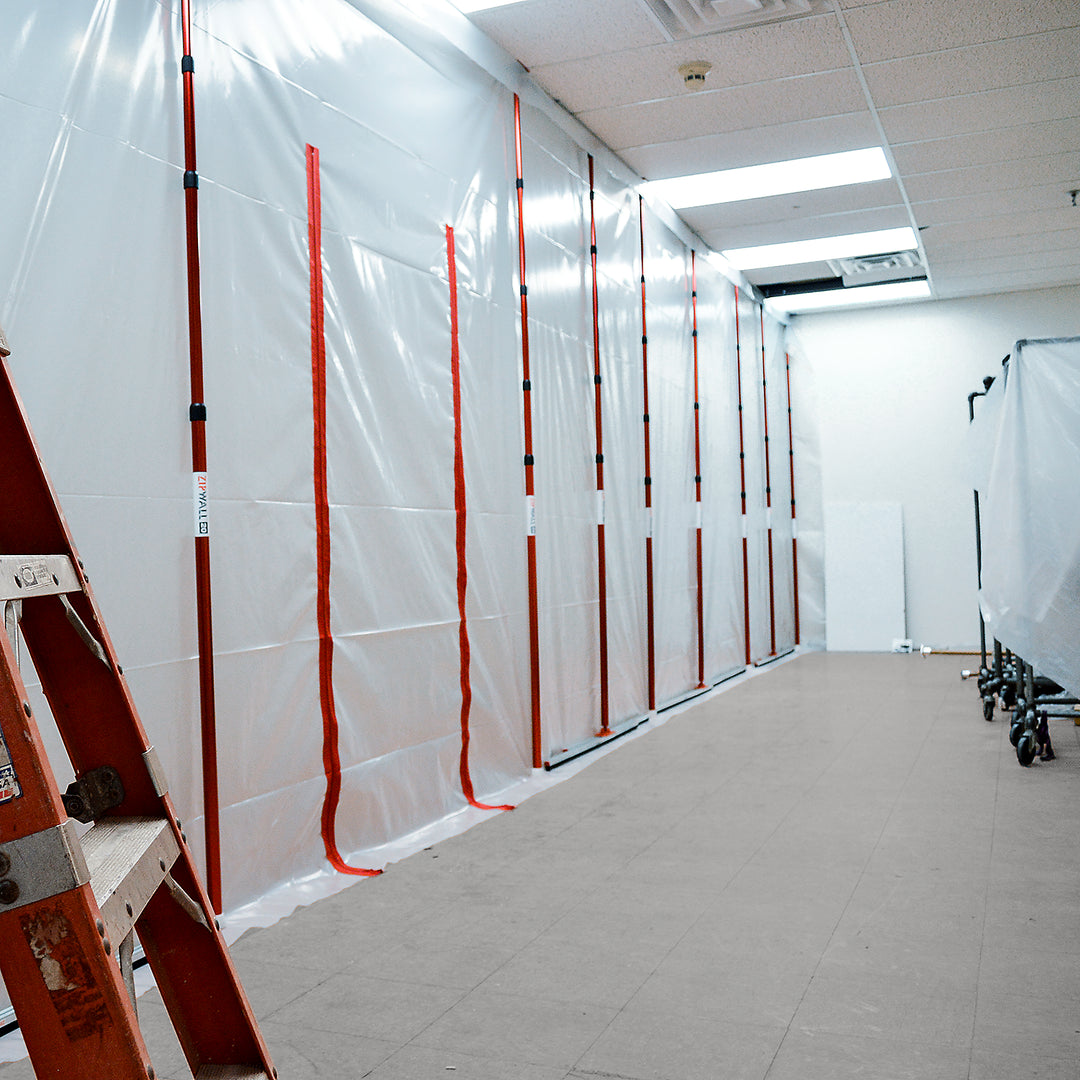ZipWall 20-foot poles set up in hallway for tall ceiling dust control

