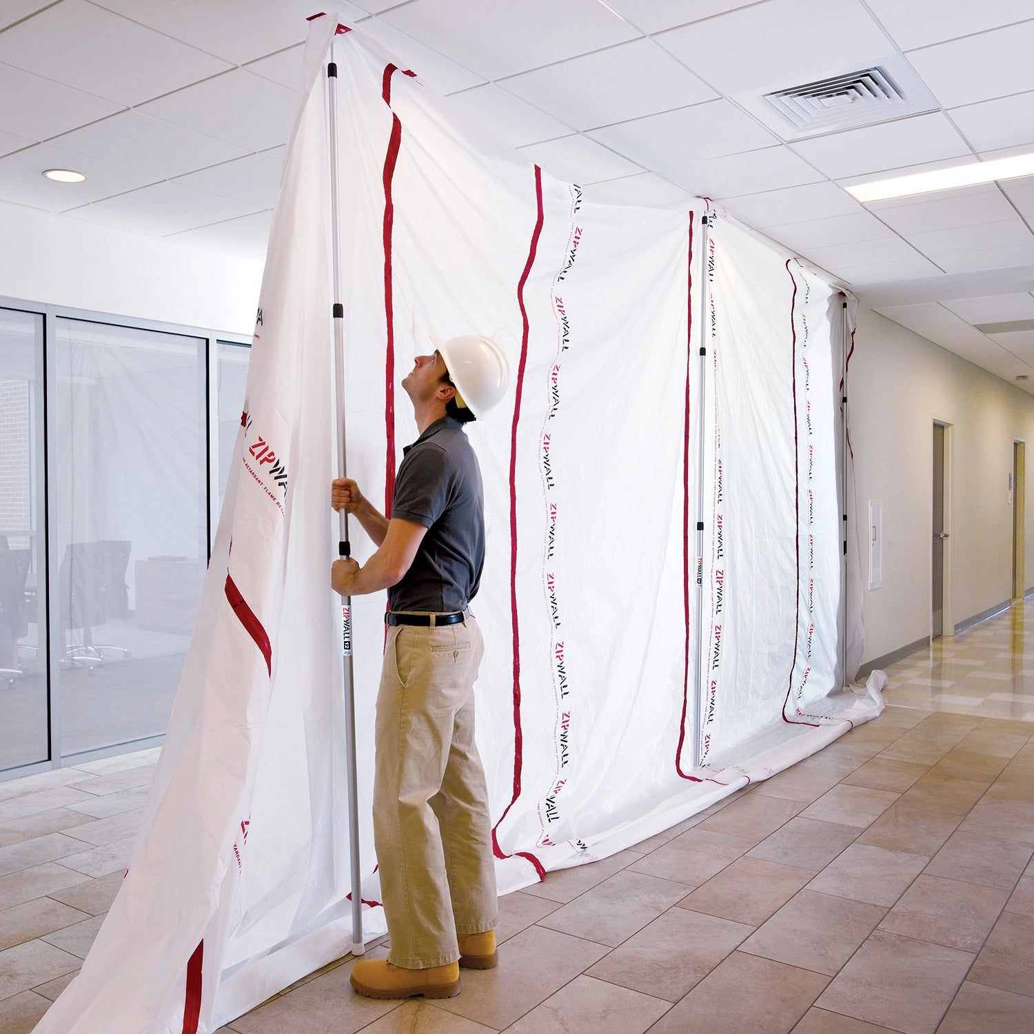 Zipwall Edge Head and Plate holding barrier securely against wall for containment
