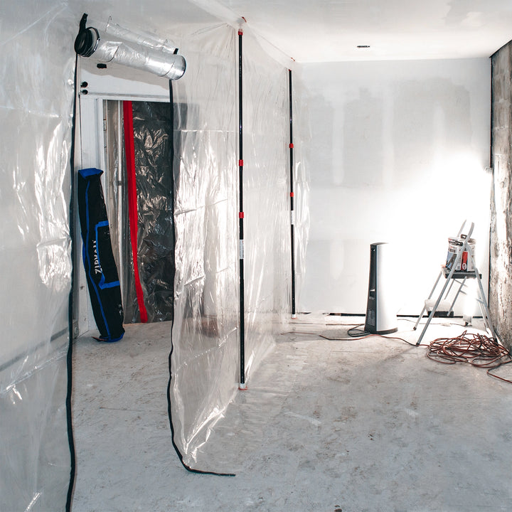 ZipWall poles installed in residential room for dust containment setup
