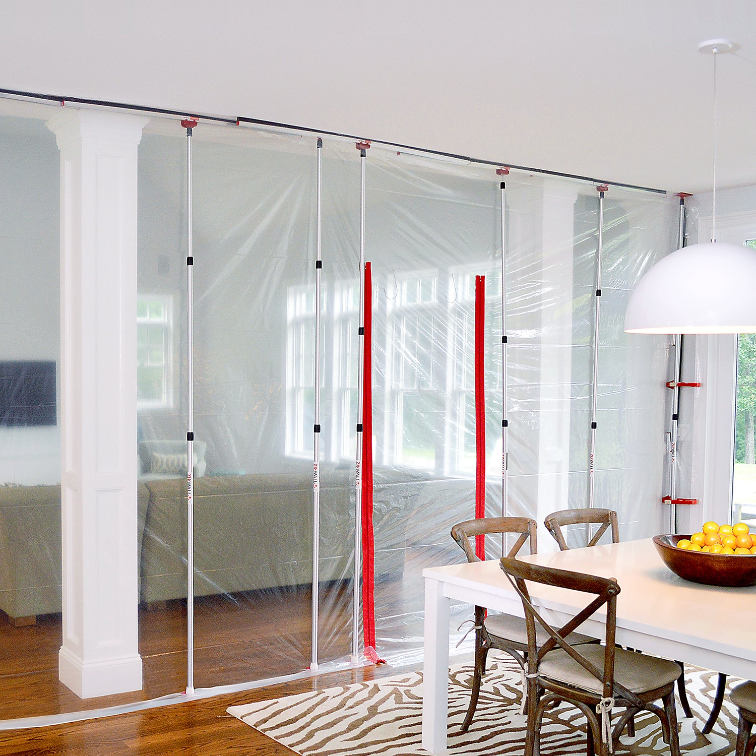 ZipWall SideClamp installed in dining room to secure plastic barrier
