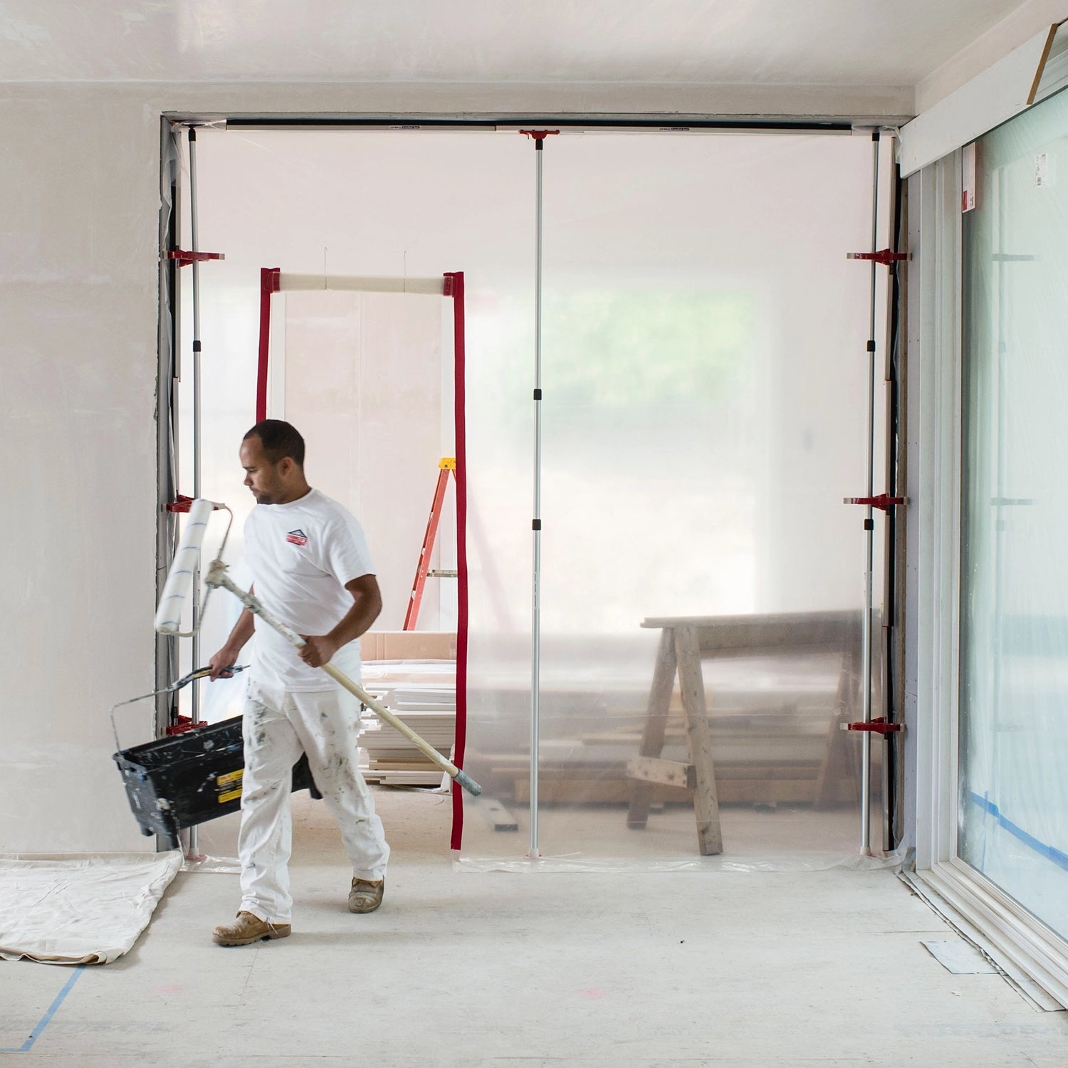 ZipWall SideClamp mounted securely on wall edge with plastic sheeting
